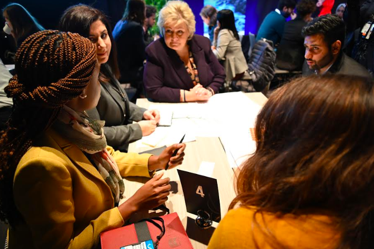 Norway's Prime Minister Erna Solberg works young leaders on their ocean solutions